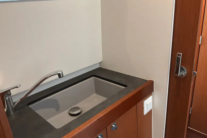 Slide: The Image of Sink area in 2017 Beneteau Swift Trawler 30, featuring modern faucet and cabinetry. - 28