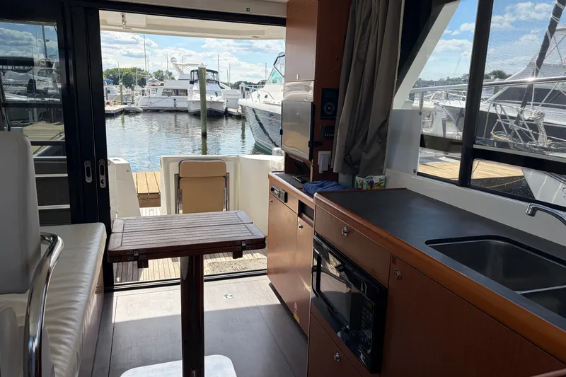 Slide: The Image of Interior of 2017 Beneteau Swift Trawler 30 with marina view through windows. - 47