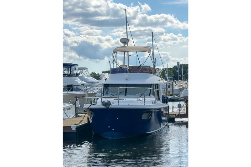 Slide: The Image of 2017 Beneteau Swift Trawler 30 docked at marina under blue sky. - 65