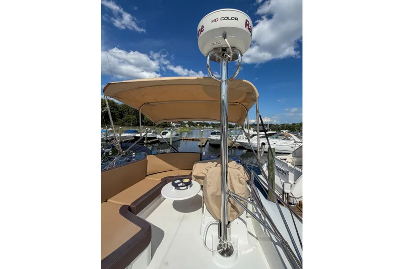 Slide: The Image of 2017 Beneteau Swift Trawler 30 with canopy and seating, docked at marina. - 62