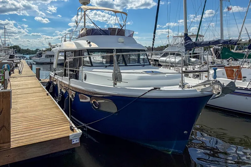 Slide: The Image of 2017 Beneteau Swift Trawler 30 docked at marina under blue sky. - 61