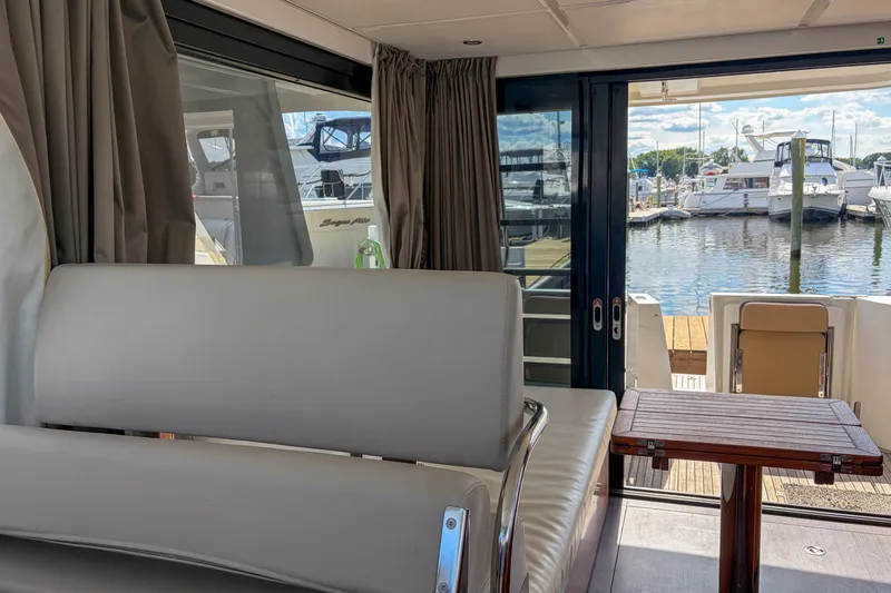 Slide: The Image of Interior view of 2017 Beneteau Swift Trawler 30 with marina backdrop. - 59