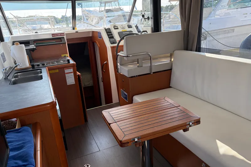 Slide: The Image of Interior of 2017 Beneteau Swift Trawler 30 with seating, table, and kitchenette. - 29