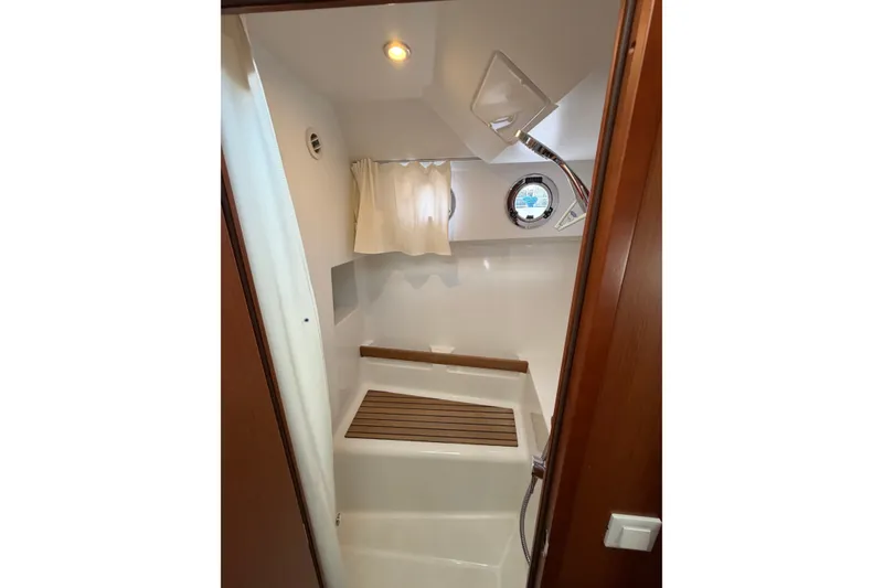 Slide: The Image of Interior shower area of 2017 Beneteau Swift Trawler 30 with wooden accents. - 41