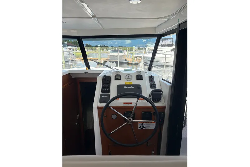Slide: The Image of 2017 Beneteau Swift Trawler 30 helm with steering wheel and navigation controls. - 45