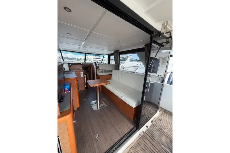 Slide: The Image of Interior of 2017 Beneteau Swift Trawler 30, featuring seating and helm station. - 36