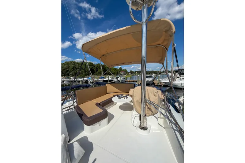 Slide: The Image of 2017 Beneteau Swift Trawler 30 flybridge with seating, canopy, and marina view. - 63
