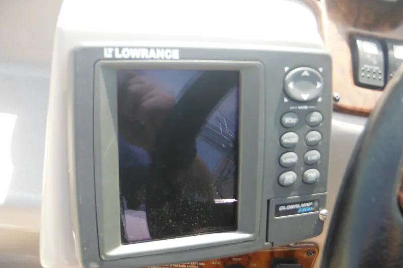 Slide: The Image of Lowrance GPS device on 2005 Rinker Fiesta Vee 250 boat dashboard. - 24