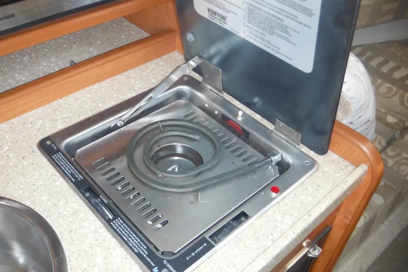 Slide: The Image of 2005 Rinker Fiesta Vee 250 boat stove in cabin kitchen area. - 40