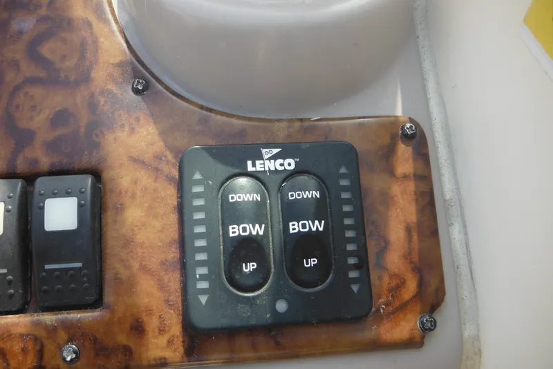 Slide: The Image of Control panel of a 2005 Rinker Fiesta Vee 250 boat with Lenco trim tab switches. - 28