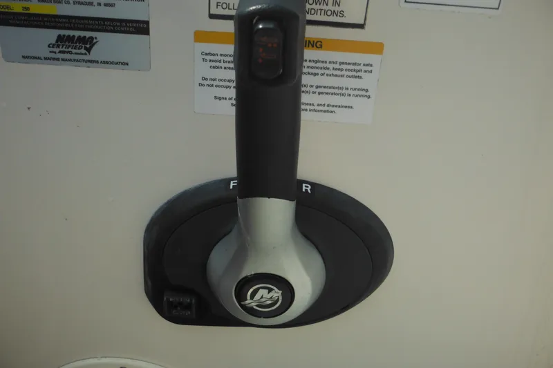 Slide: The Image of Throttle control lever on a 2005 Rinker Fiesta Vee 250 boat dashboard. - 51