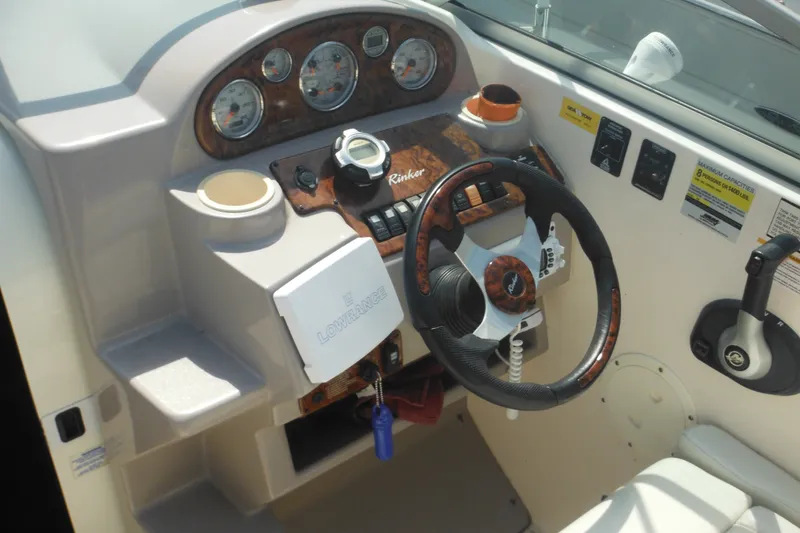 Slide: The Image of 2005 Rinker Fiesta Vee 250 boat dashboard with steering wheel and control panel. - 20