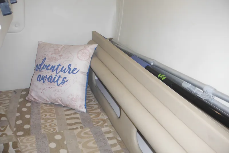 Slide: The Image of 2005 Rinker Fiesta Vee 250 cabin interior with decorative pillow and patterned bedding. - 43