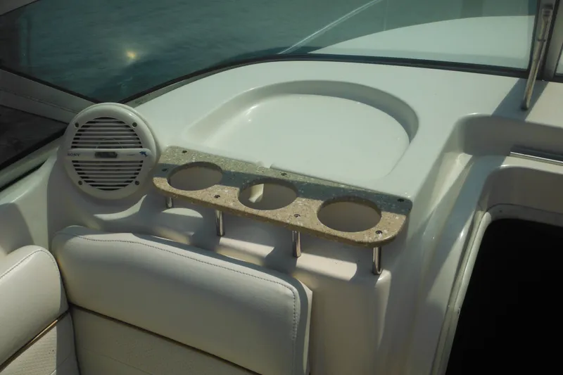 Slide: The Image of 2005 Rinker Fiesta Vee 250 boat interior with cup holders and speaker. - 19