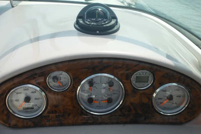 Slide: The Image of Dashboard of 2005 Rinker Fiesta Vee 250 boat with gauges and compass. - 29