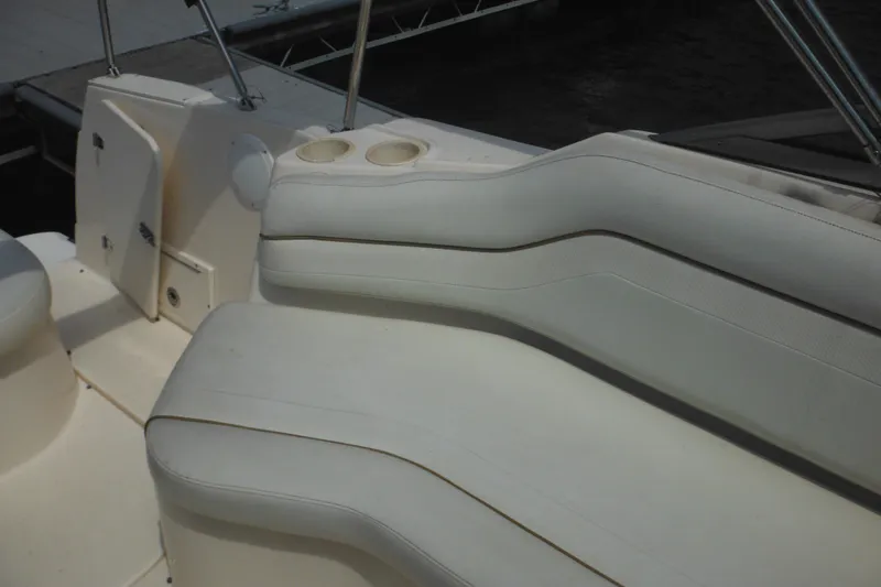 Slide: The Image of 2005 Rinker Fiesta Vee 250 boat interior with white seating and cup holders. - 49