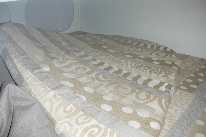 Slide: The Image of Cozy cabin interior of 2005 Rinker Fiesta Vee 250 with patterned bedding. - 42