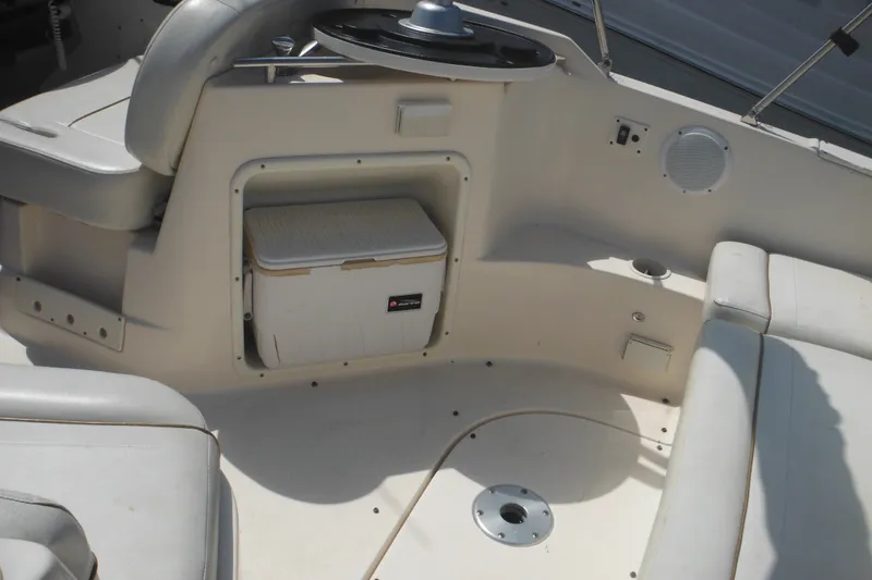 Slide: The Image of 2005 Rinker Fiesta Vee 250 boat interior with seating and storage compartment. - 13