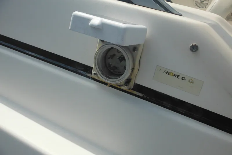 Slide: The Image of 2005 Rinker Fiesta Vee 250 shore power connection on boat exterior. - 59