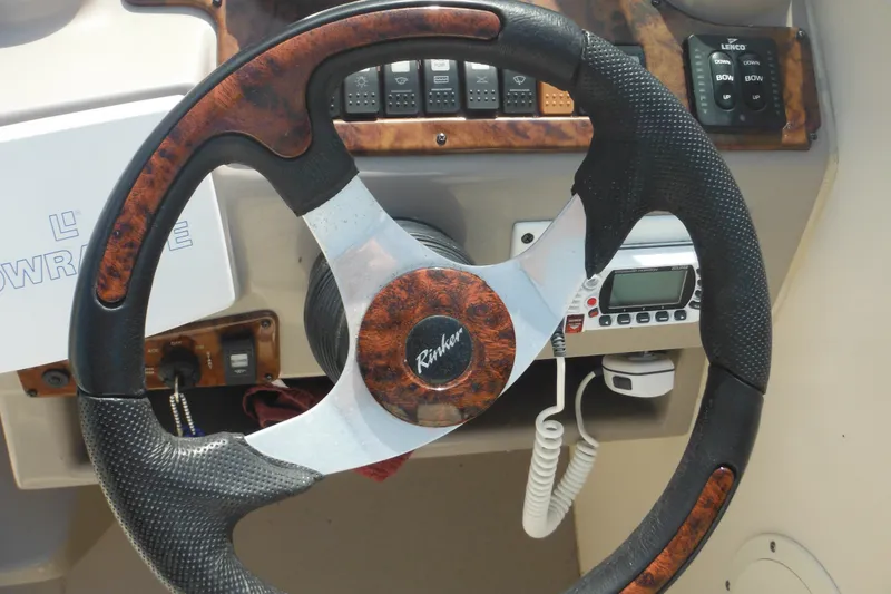 Slide: The Image of Steering wheel of a 2005 Rinker Fiesta Vee 250 boat with control panel. - 23