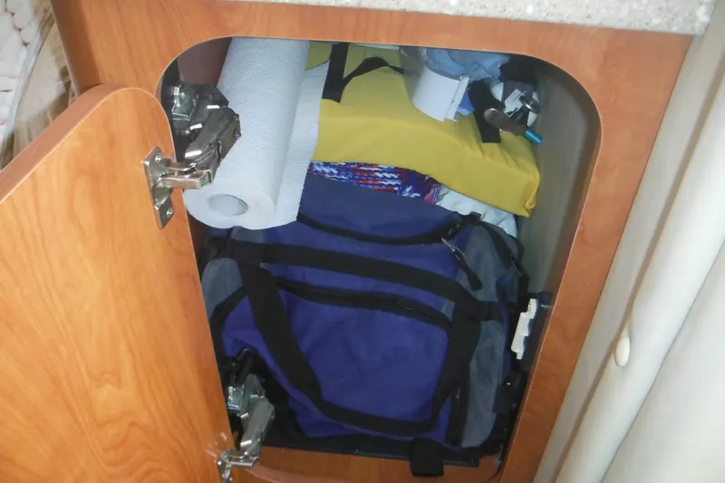 Slide: The Image of Storage cabinet in a 2005 Rinker Fiesta Vee 250 boat with bags and supplies. - 36