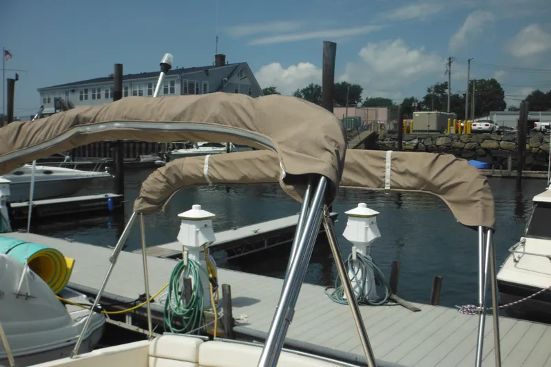 Slide: The Image of 2005 Rinker Fiesta Vee 250 boat docked at marina with covered canopy. - 58