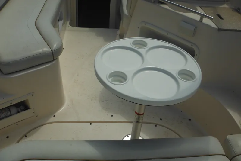 Slide: The Image of 2005 Rinker Fiesta Vee 250 boat interior with round table and seating area. - 55