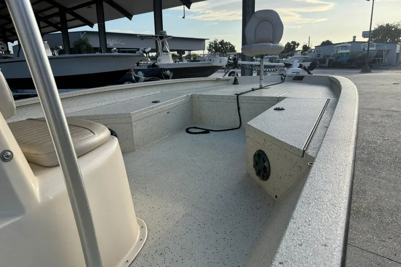 Slide: The Image of 2015 Xpress H24 Bay boat interior with seating and storage compartments. - 15