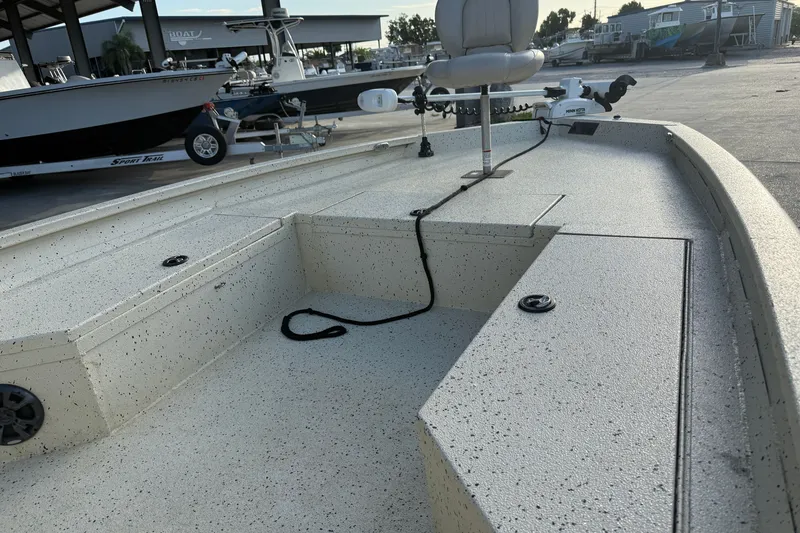 Slide: The Image of 2015 Xpress H24 Bay boat interior with seating and storage compartments. - 16