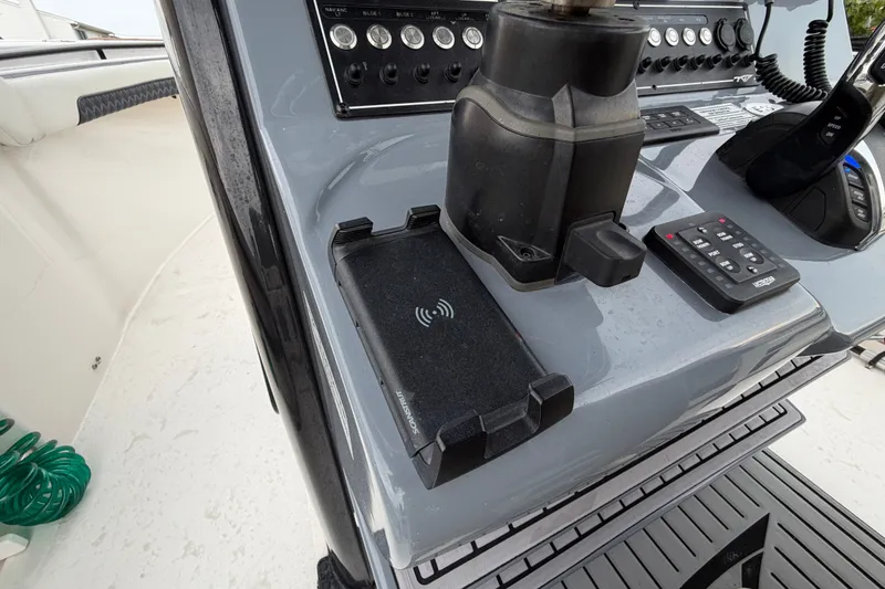 Slide: The Image of Control panel of 2023 Tidewater 282 CC Adventure Bluewater boat with wireless charging pad. - 16