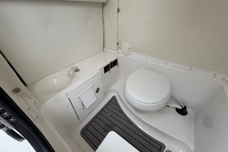 Slide: The Image of 2023 Tidewater 282 CC Adventure Bluewater boat interior bathroom with toilet and sink. - 26