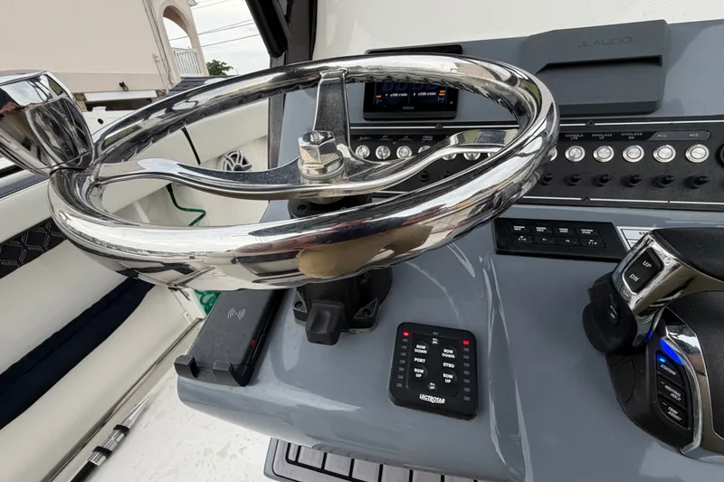 Slide: The Image of Steering console of 2023 Tidewater 282 CC Adventure Bluewater boat with modern controls. - 15