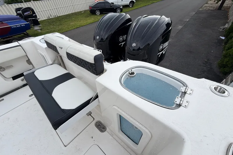 Slide: The Image of 2023 Tidewater 282 CC Adventure Bluewater boat with Yamaha engines and seating area. - 21