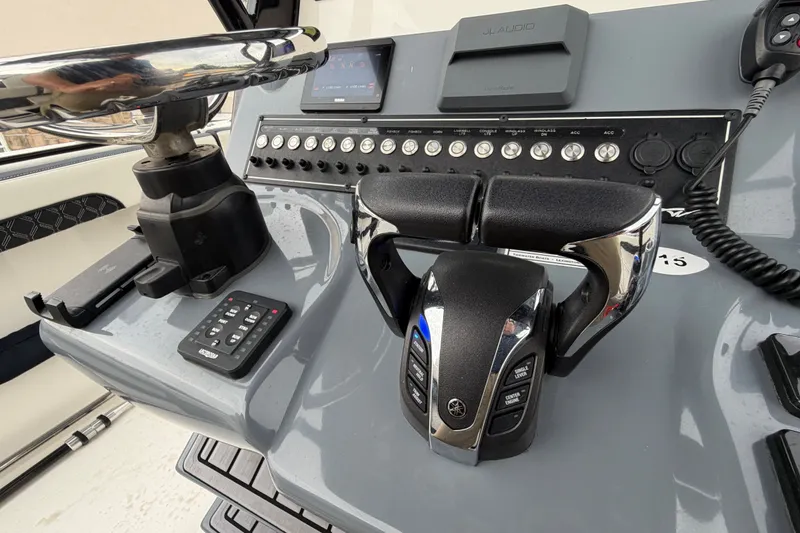 Slide: The Image of Control panel of 2023 Tidewater 282 CC Adventure Bluewater boat with steering and throttle. - 14