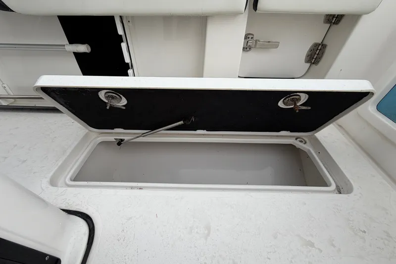 Slide: The Image of Open storage compartment on 2023 Tidewater 282 CC Adventure Bluewater boat deck. - 24