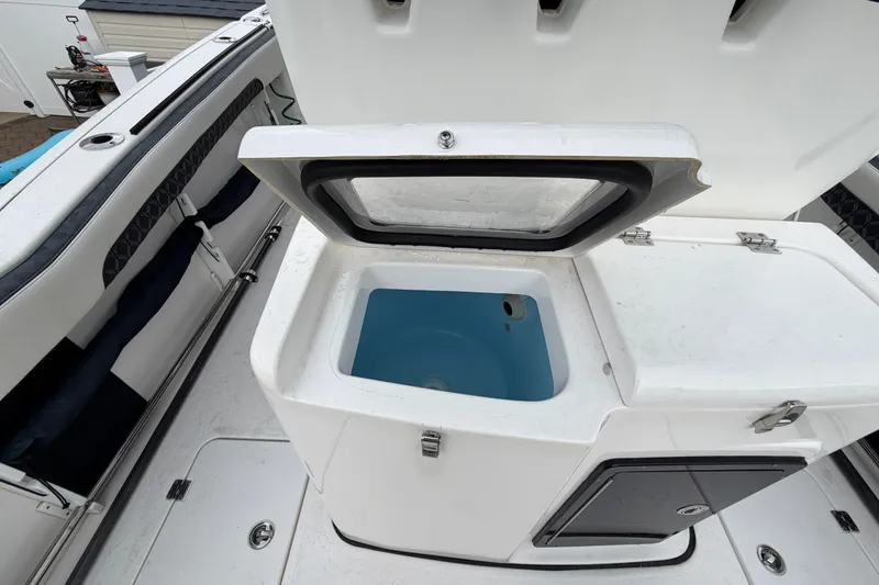 Slide: The Image of Open storage compartment on 2023 Tidewater 282 CC Adventure Bluewater boat. - 19