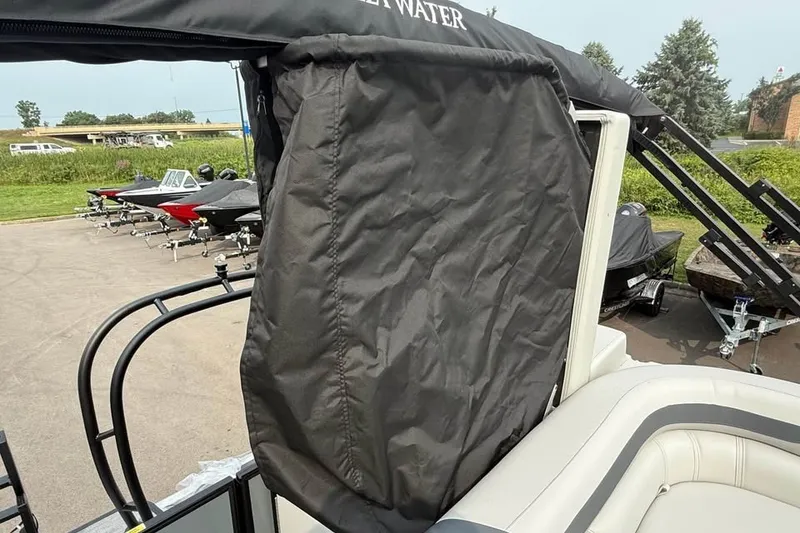 Slide: The Image of 2027 Godfrey Sweetwater 2086 C pontoon boat with black canopy in a parking lot. - 15