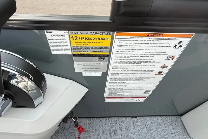Slide: The Image of 2027 Godfrey Sweetwater 2086 C capacity warning labels and controls. - 18