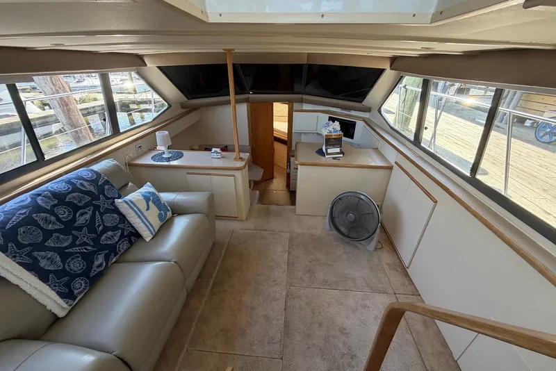 Slide: The Image of Interior of 1996 Carver 370 Aft Cabin Motor Yacht with cozy seating and decor. - 14