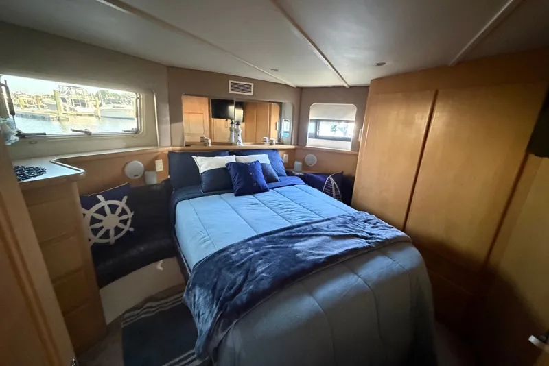 Slide: The Image of Cozy bedroom in 1996 Carver 370 Aft Cabin Motor Yacht with nautical decor. - 23