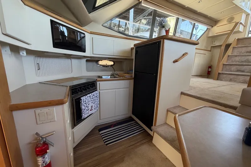 Slide: The Image of Interior of 1996 Carver 370 Aft Cabin Motor Yacht with kitchen and stairs. - 17