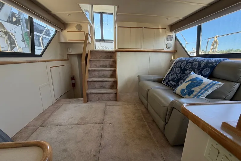 Slide: The Image of Interior of 1996 Carver 370 Aft Cabin Motor Yacht with cozy seating and nautical decor. - 16