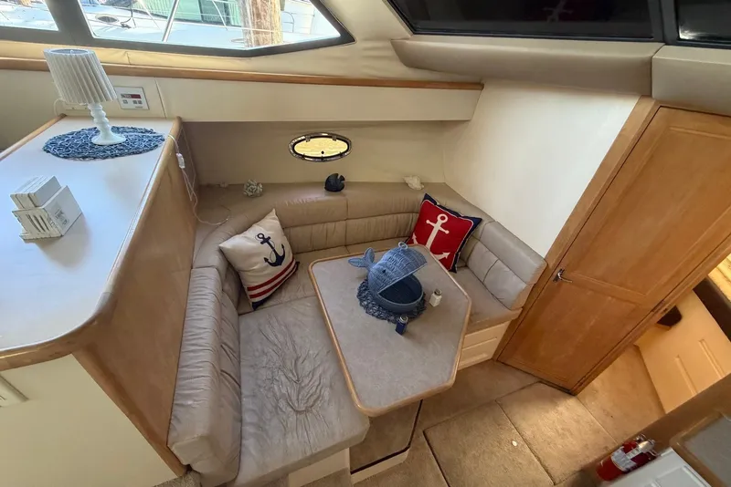 Slide: The Image of Interior of 1996 Carver 370 Aft Cabin Motor Yacht with cozy seating and nautical decor. - 19