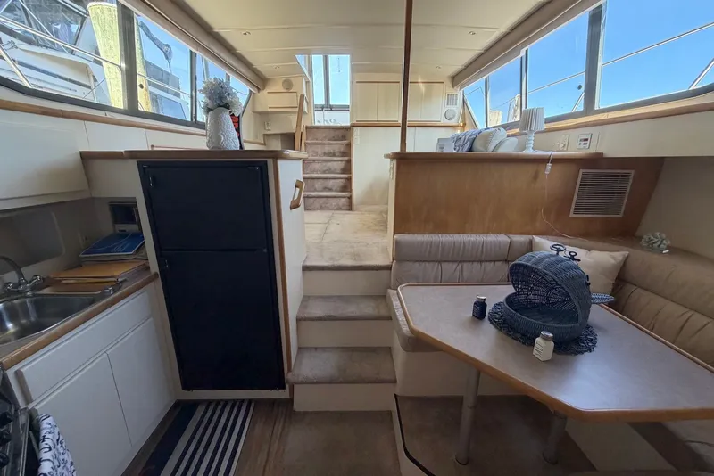 Slide: The Image of Interior of 1996 Carver 370 Aft Cabin Motor Yacht with dining area and kitchenette. - 18