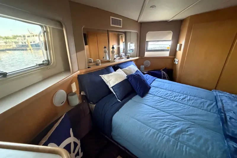Slide: The Image of Cozy bedroom in 1996 Carver 370 Aft Cabin Motor Yacht with nautical decor. - 24