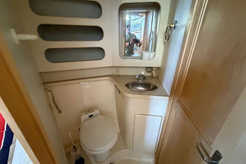 Slide: The Image of Bathroom interior of 1996 Carver 370 Aft Cabin Motor Yacht, featuring sink and toilet. - 21