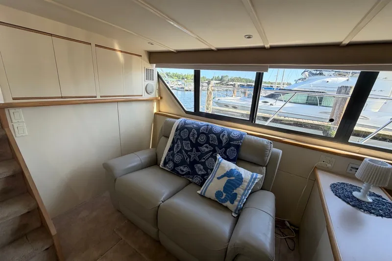 Slide: The Image of Interior of 1996 Carver 370 Aft Cabin Motor Yacht with cozy seating and nautical decor. - 15