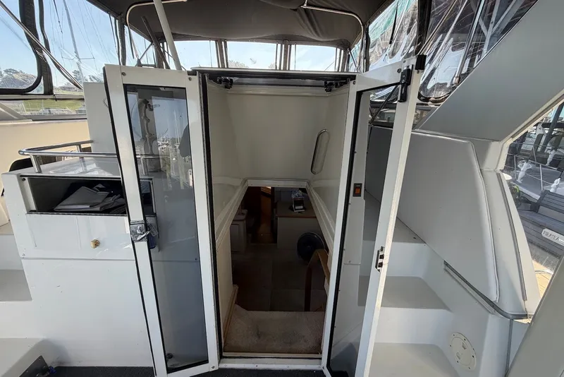 Slide: The Image of 1996 Carver 370 Aft Cabin Motor Yacht interior entrance with open doors and visible stairs. - 13