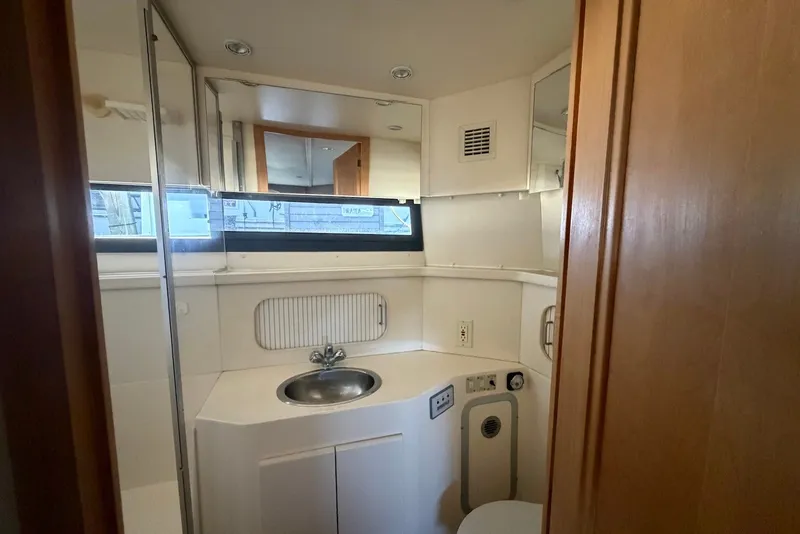 Slide: The Image of Bathroom interior of 1996 Carver 370 Aft Cabin Motor Yacht, featuring sink and mirror. - 26