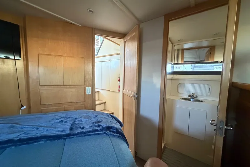 Slide: The Image of Interior of 1996 Carver 370 Aft Cabin Motor Yacht with cozy bedroom and bathroom. - 25